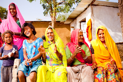 a group of people sitting together talking and laughing