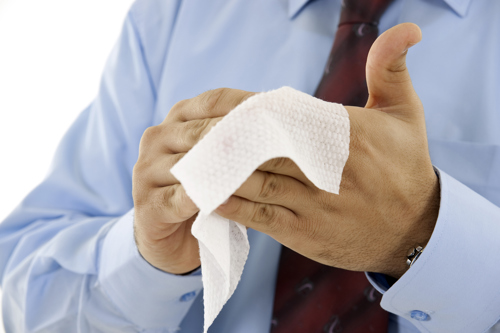 a man using wet wipes to clean his hands