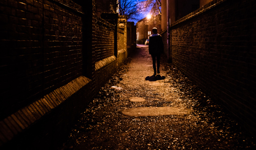 person walking in the dark alone