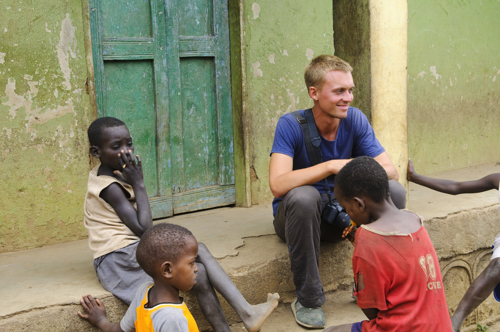 charity worker sitting down talking with children