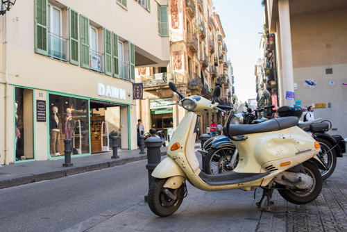 moped parked on the side of the street