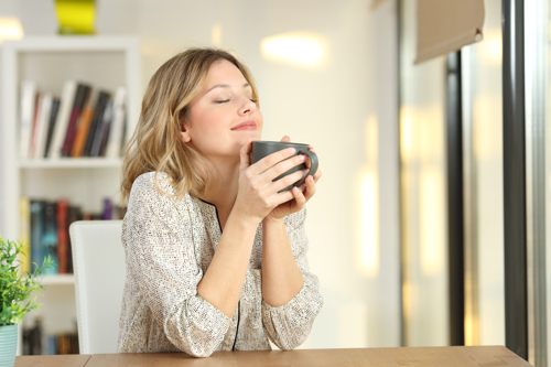 woman enjoying her drink and relaxing